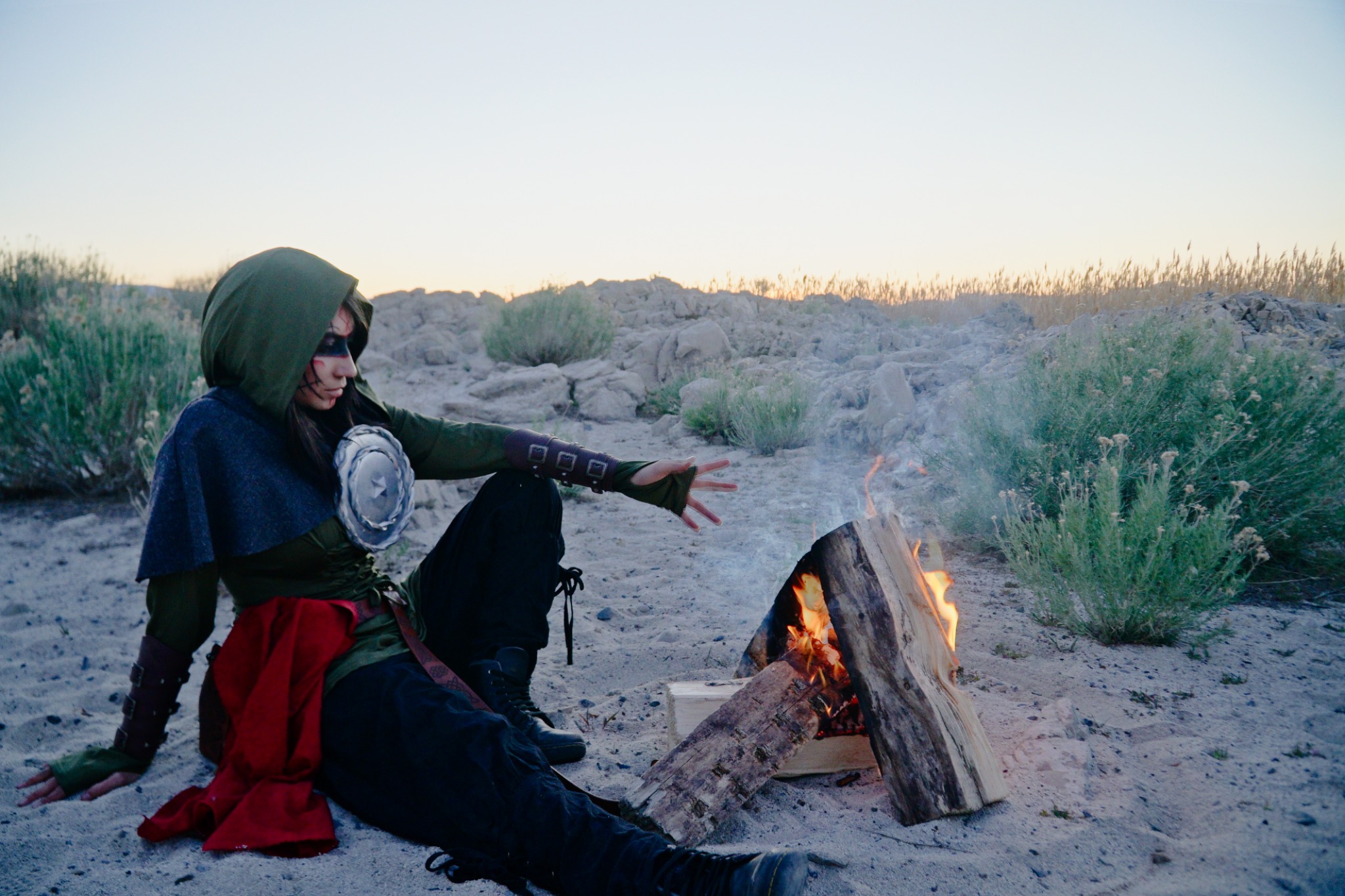 Character seated by campfire